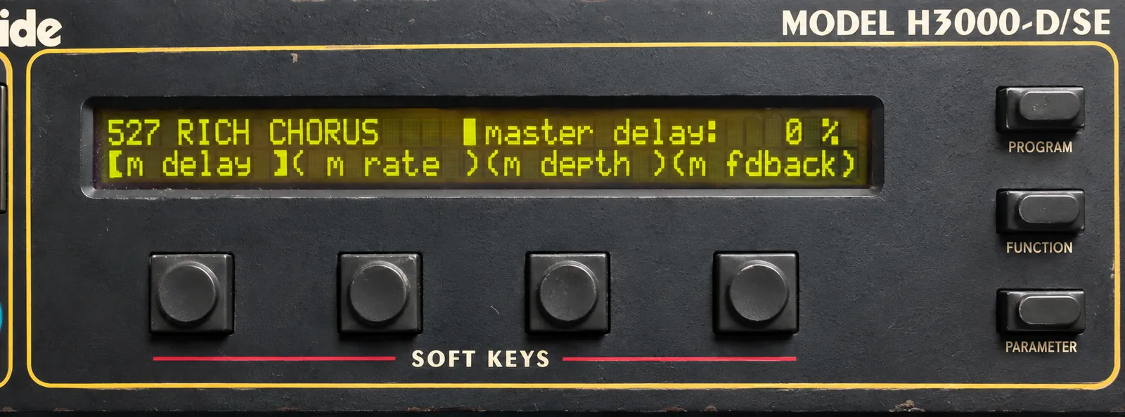 The yellow-green LCD shows “527 RICH CHORUS” and “master delay: 0 %” above m delay, m rate, m depth and m fdback. Four soft keys sit below, with PROGRAM, FUNCTION and PARAMETER buttons on the right and MODEL H3000-D/SE above.